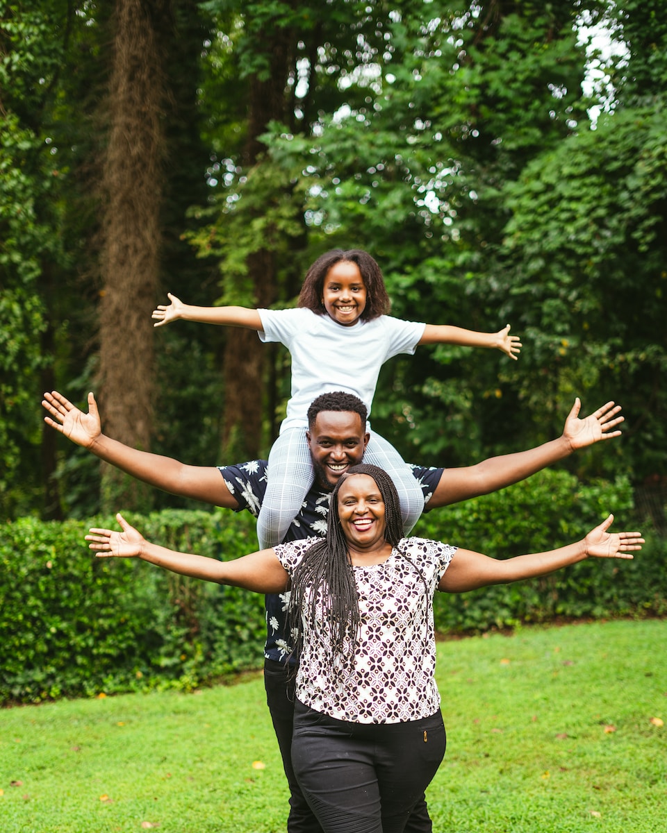 a group of people that are standing in the grass